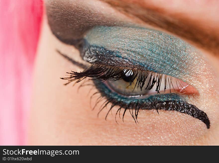 Beautiful woman's open  eye with colorful makeup