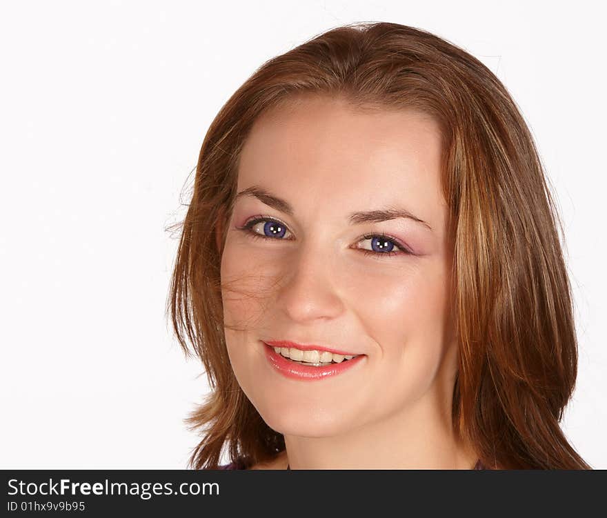 Brunette with hair in face enjoying life and smiling. Brunette with hair in face enjoying life and smiling