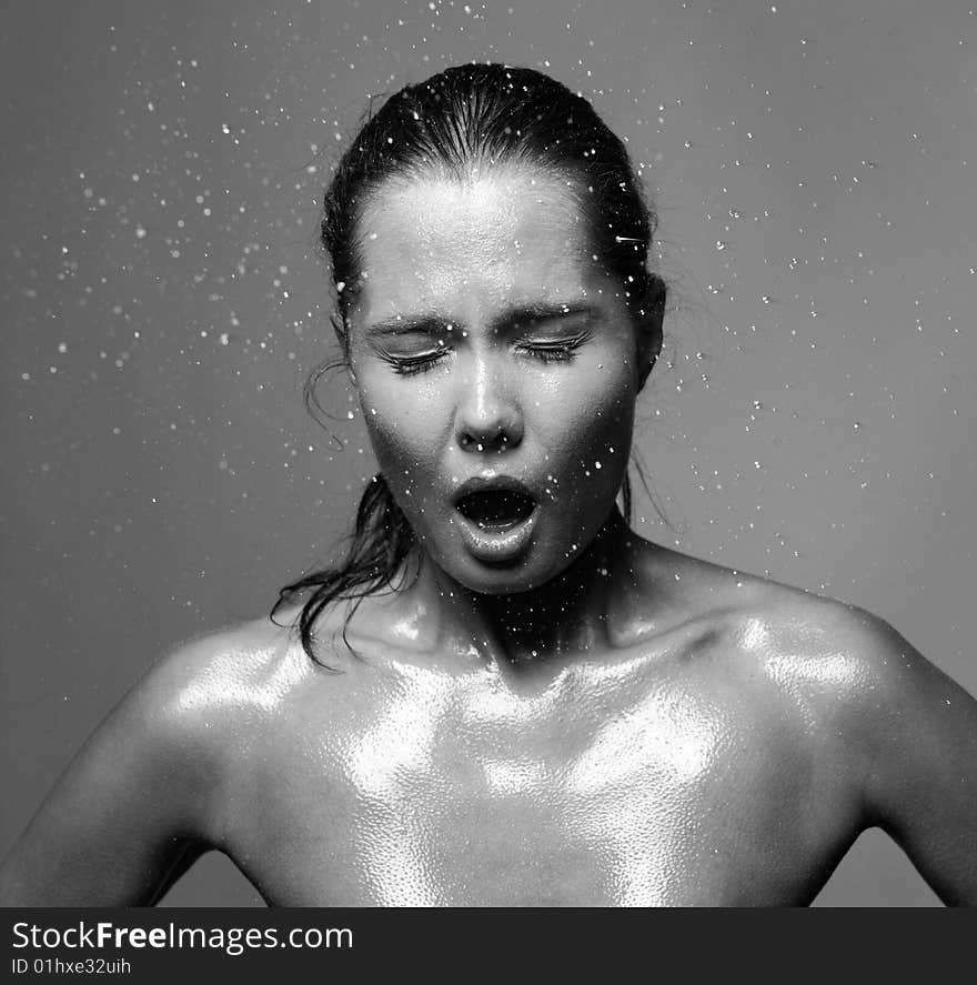 Portrait of young woman with drops of water