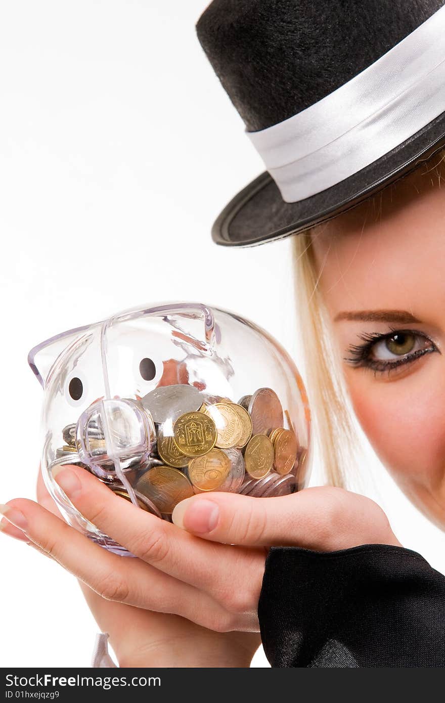 Woman holding transparent piggybank with coins. Isolated