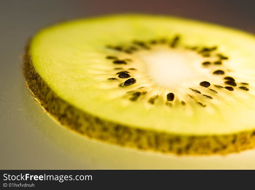 Slide of kiwi on the glasses background.