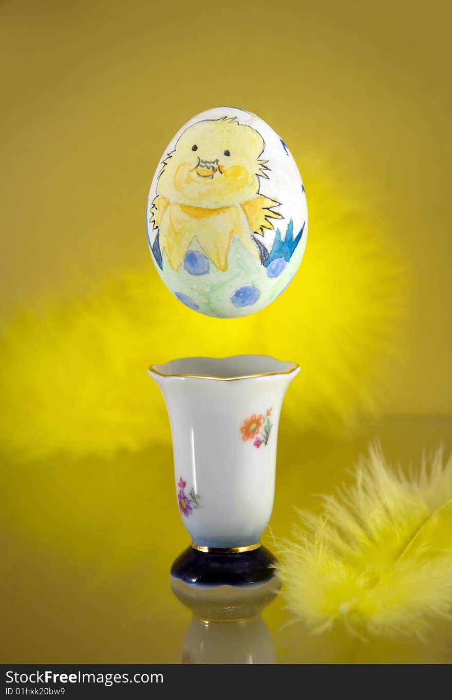 Painted egg hovering over an egg cup. Painted egg hovering over an egg cup