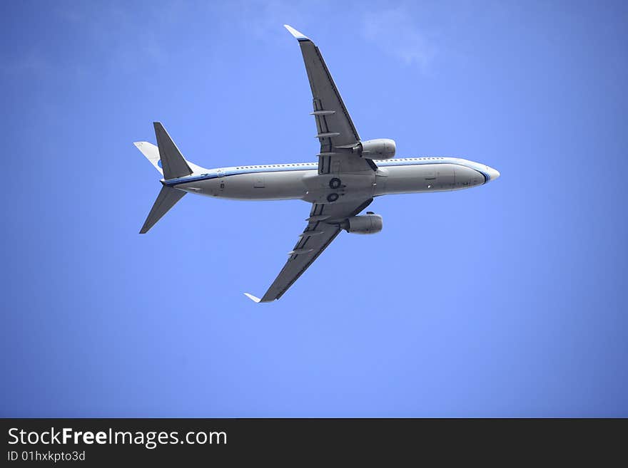 The airplane on  the blue sky background. The airplane on  the blue sky background.