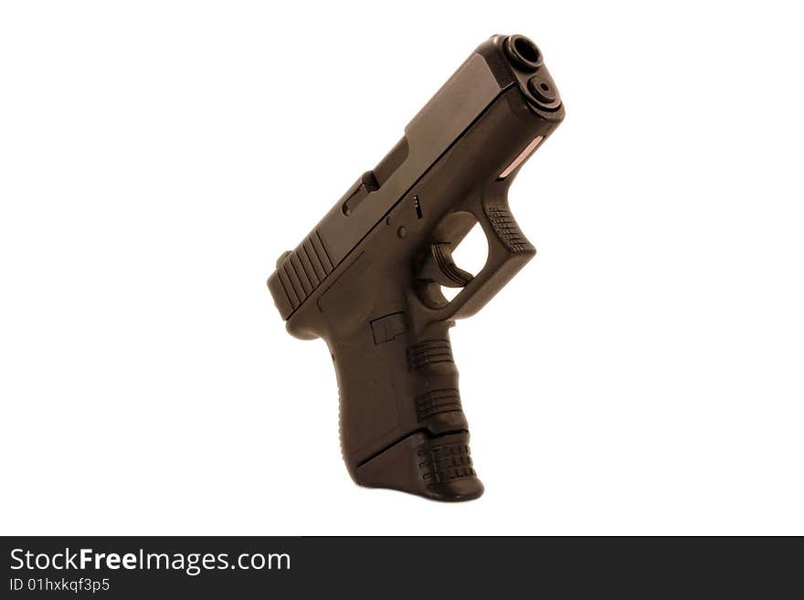 A modern day compact pistol isolated on a white background.