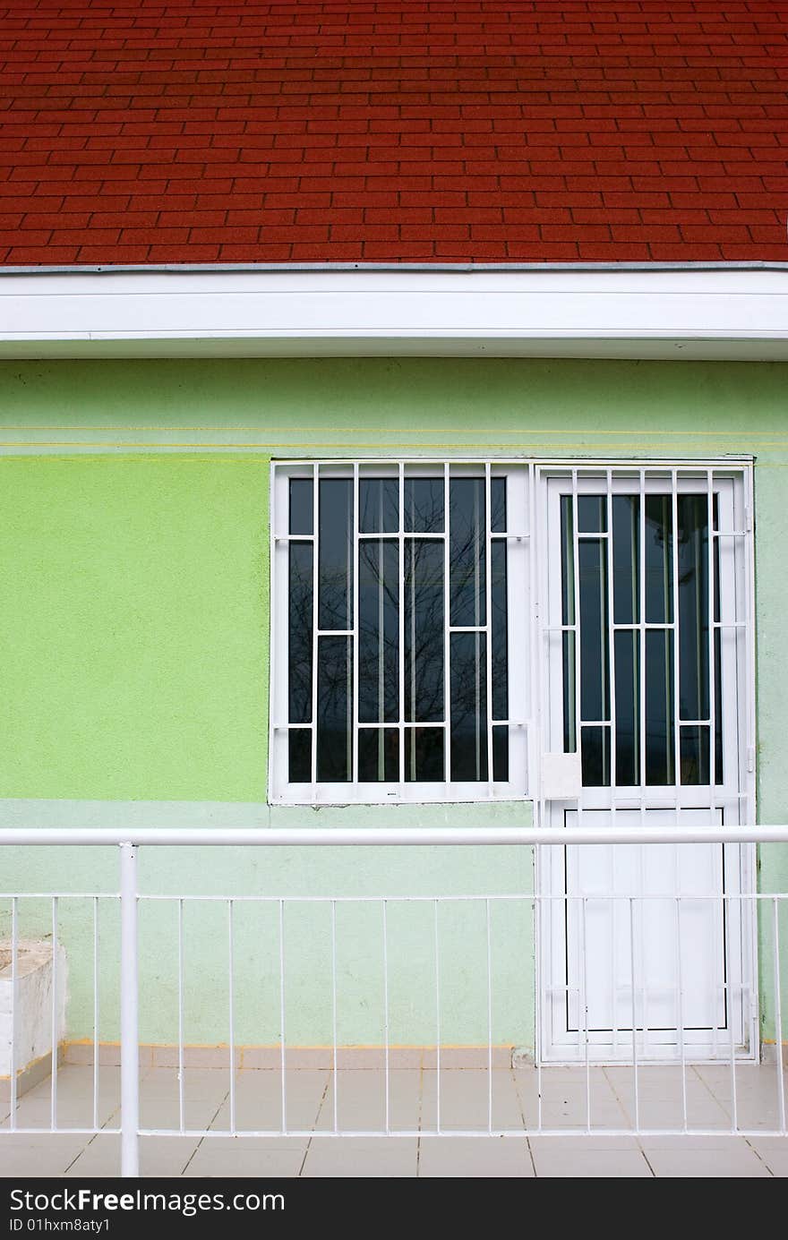 Holiday house with green wall and porch