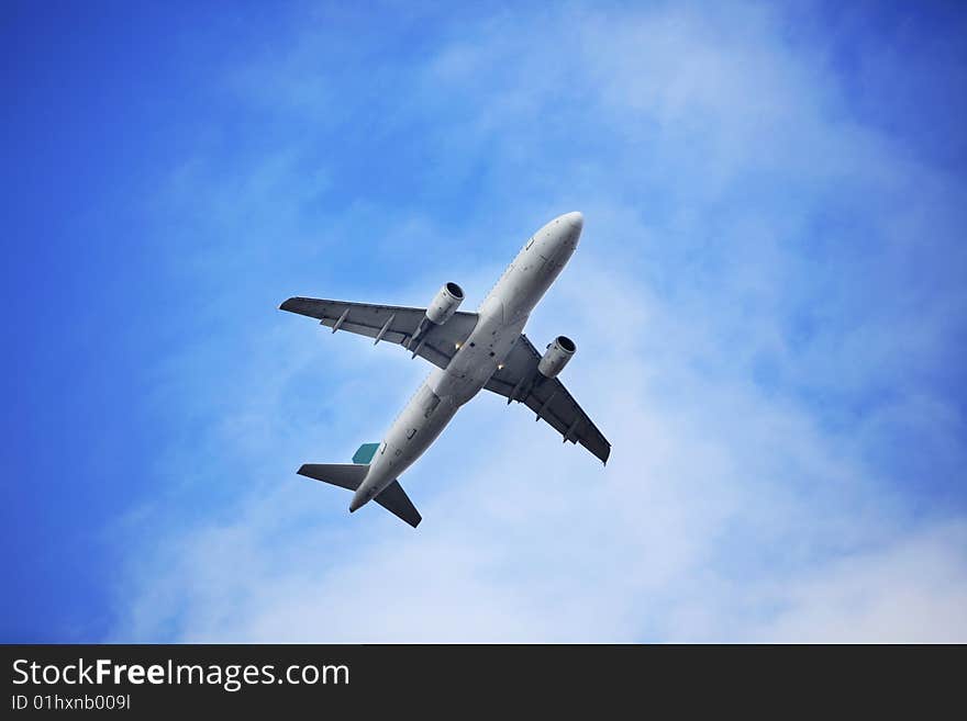 The airplane on  the blue sky background. The airplane on  the blue sky background.