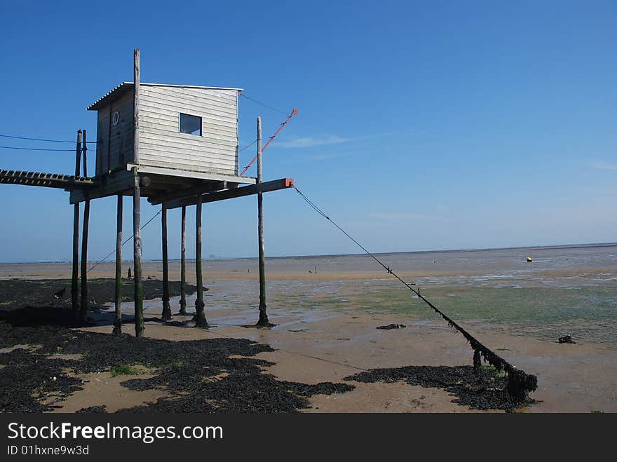 Fishing house at low tide in France