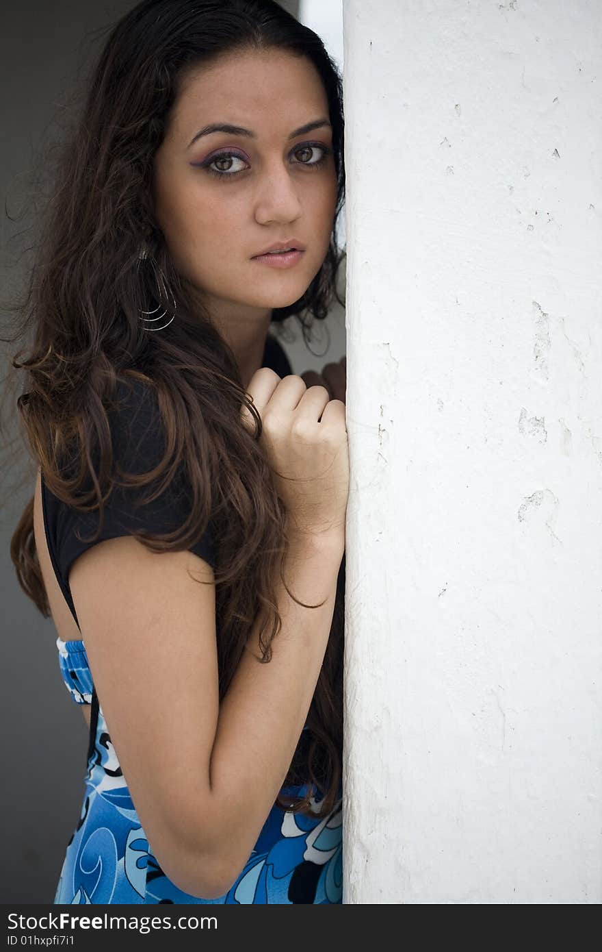 Blue Dress Next To White Wall