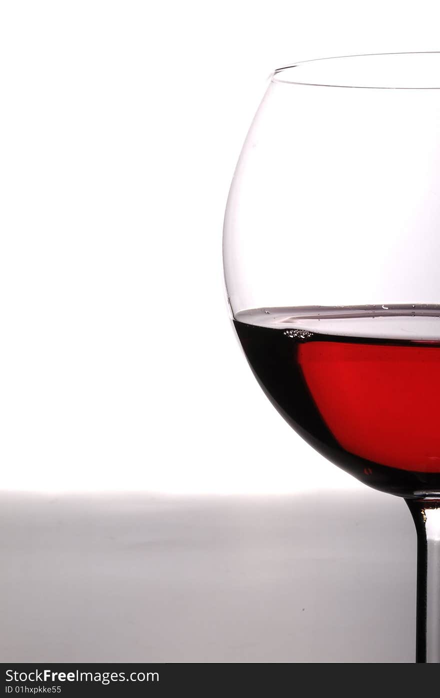 A glass of red wine on grey isolated on white with reflection