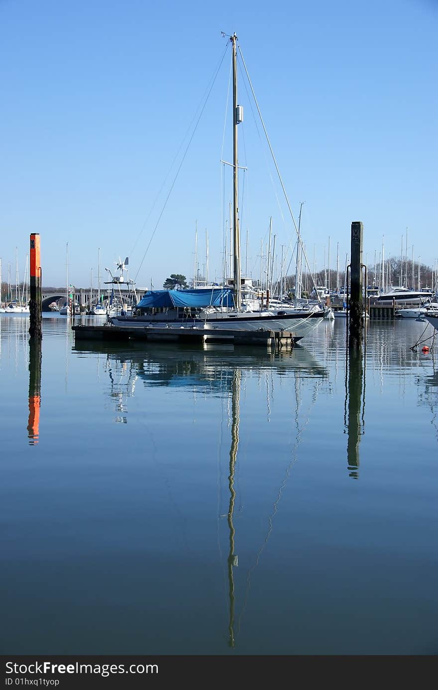 Image of yachts reflected in water. Image of yachts reflected in water