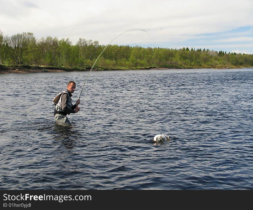 Fly fishing on river - fight with fish