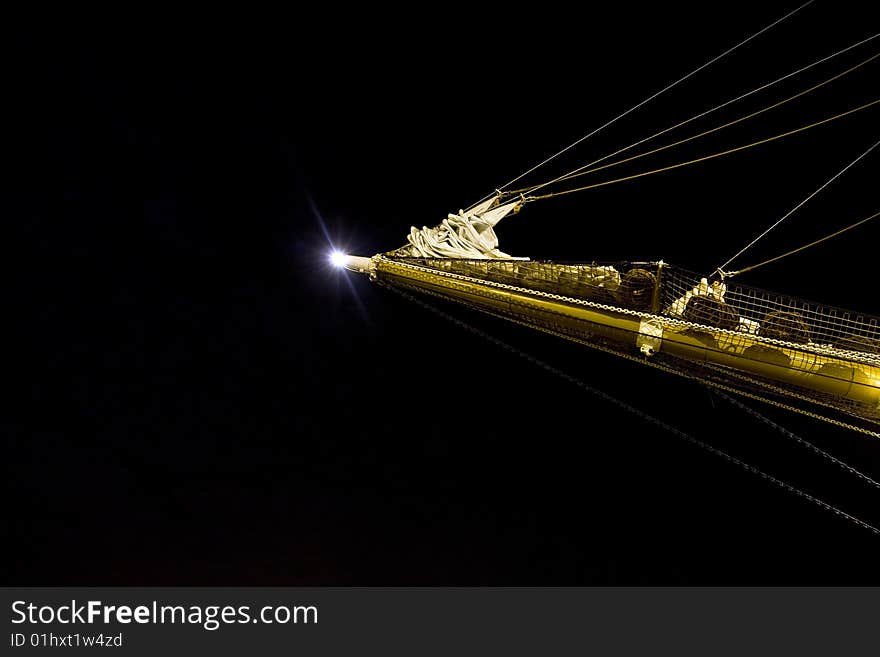 Night view of a bowsprit of a sailing ship wooden overlap with the moon in the background