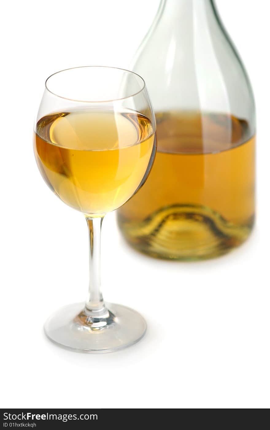 Glass and bottle of excellent white wine on a white background