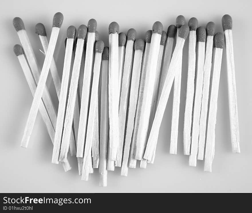 Wooden matches in black & white on white background