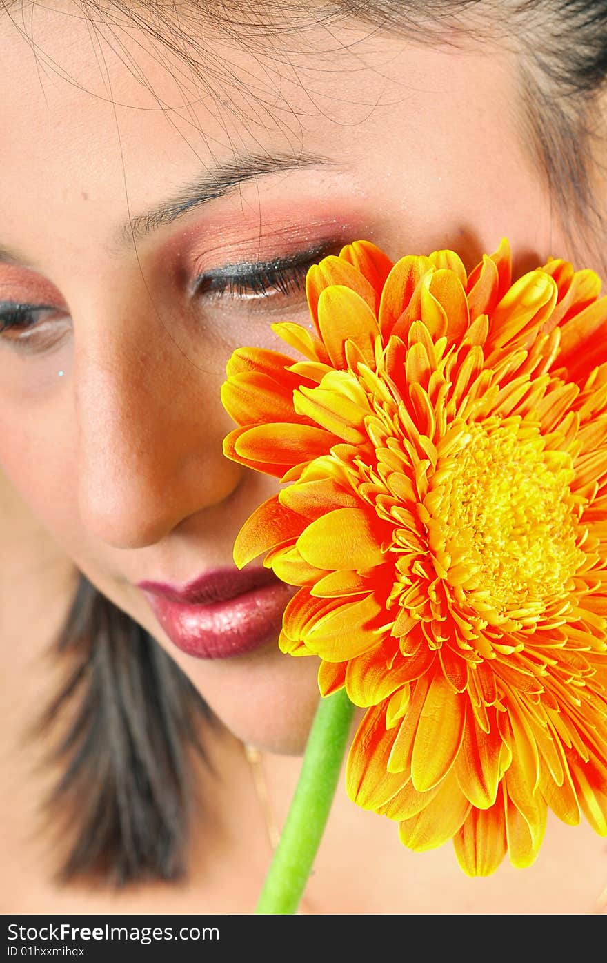 Indian girl model holding a orange flower. Indian girl model holding a orange flower.