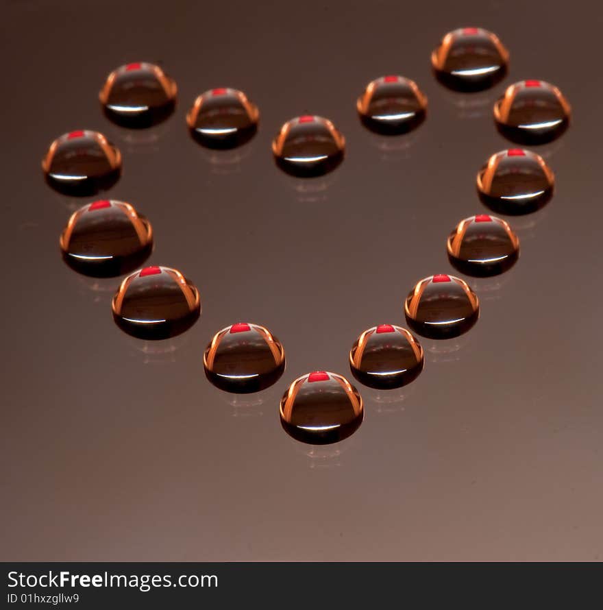 Water drops in the form of heart on a celebratory background