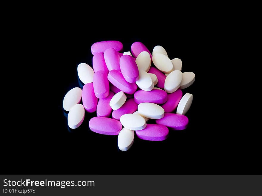 Colored oblong pills on the isolated background