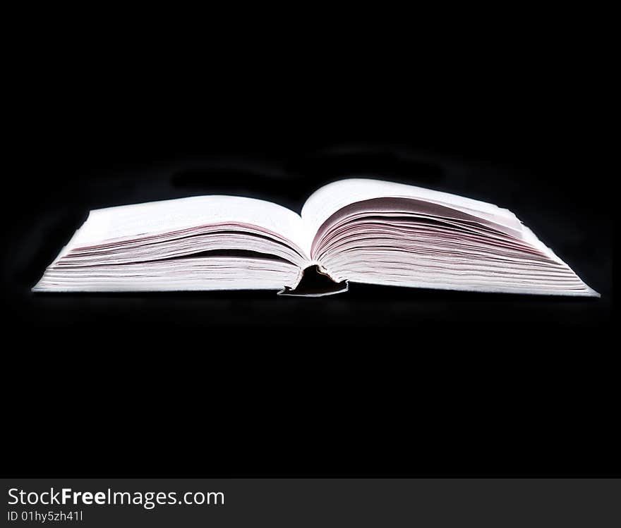 Opened book isolated on black background. Opened book isolated on black background