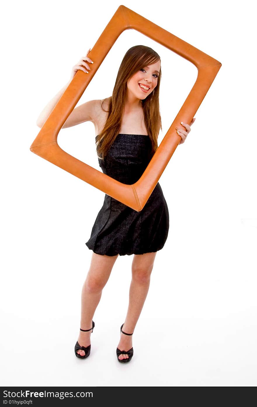 Front view of smiling woman holding frame against white background