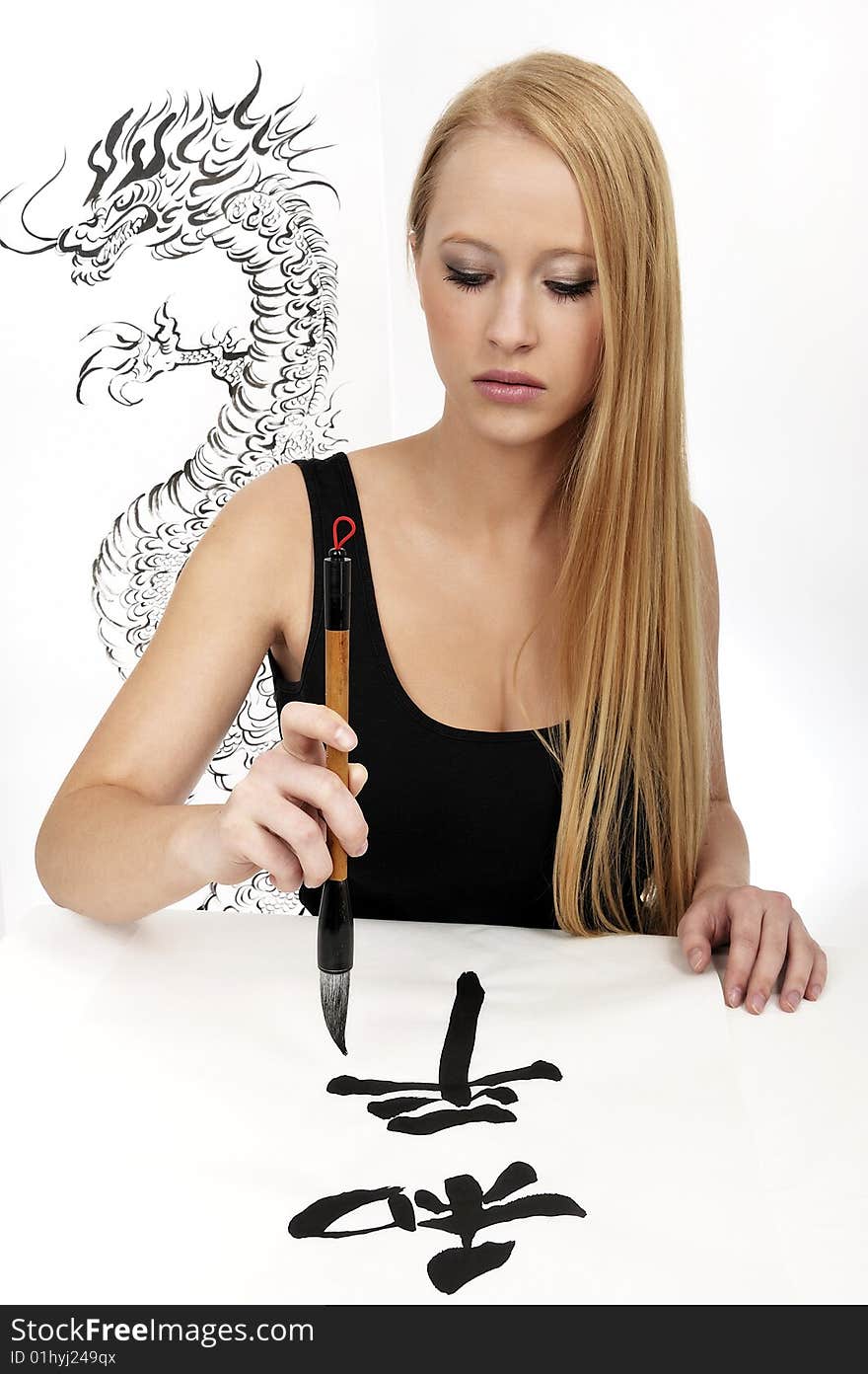 Blond woman writing Chinese Calligraphy: Peace