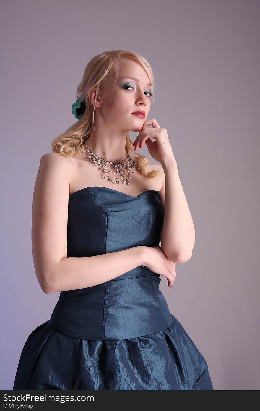 Beautiful young woman wearing a blue prom dress. Beautiful young woman wearing a blue prom dress