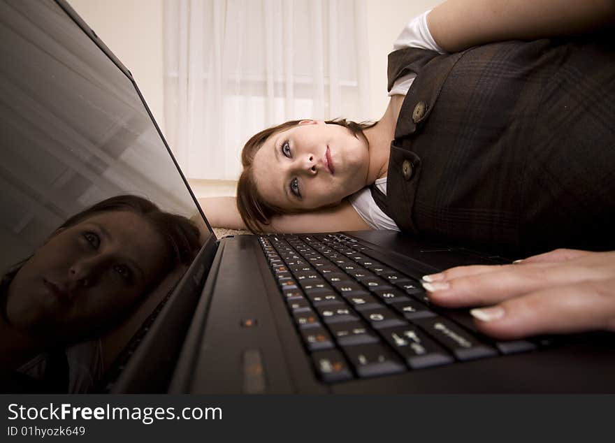 Woman with laptop on carpet