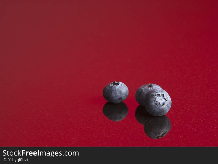 Blueberries on red background