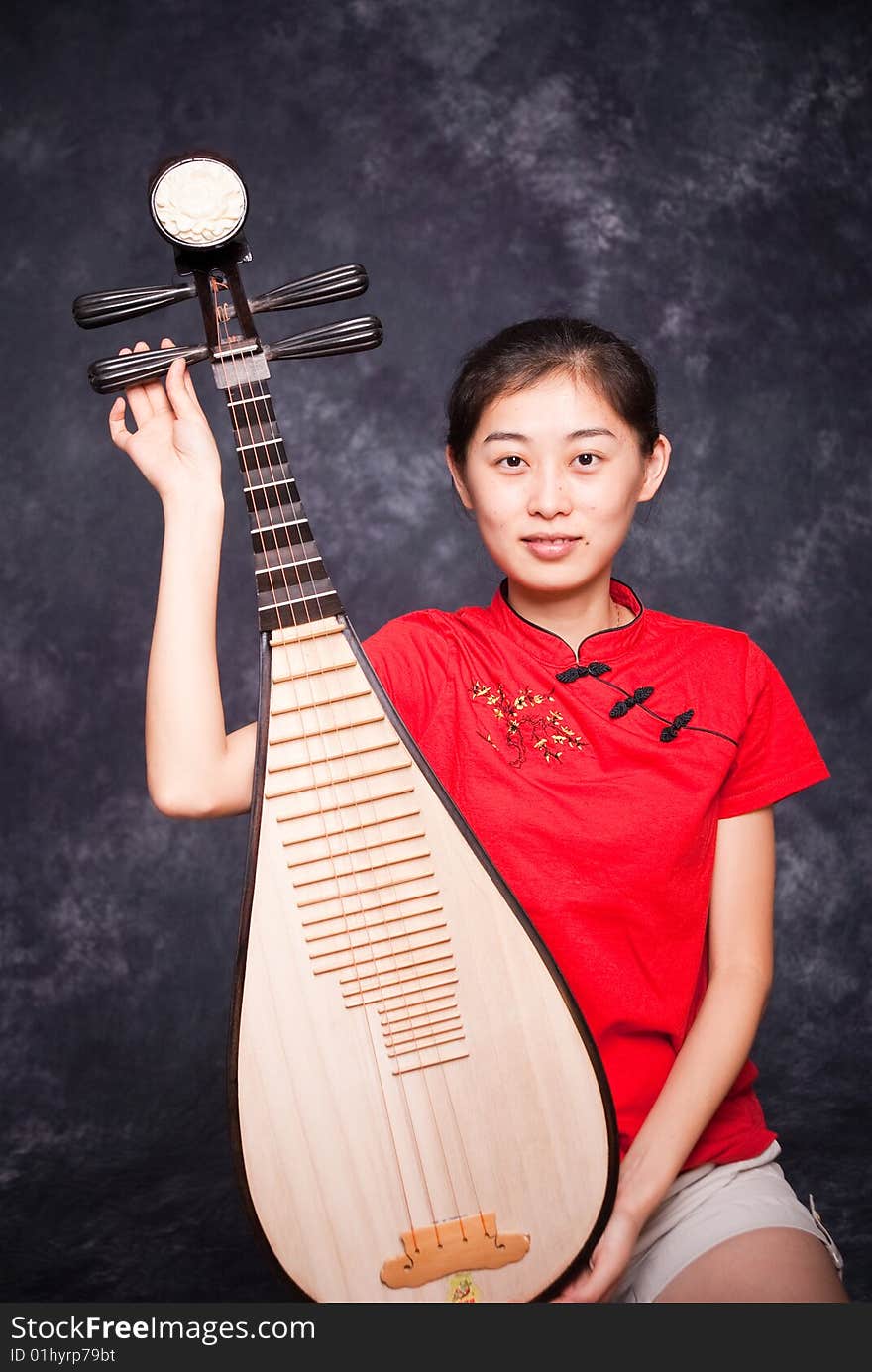 Chinese lute player in red shirt on performance. Chinese lute player in red shirt on performance