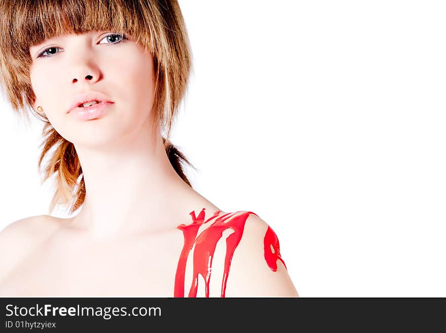 Studio portrait of a teenage girl painting herself. Studio portrait of a teenage girl painting herself