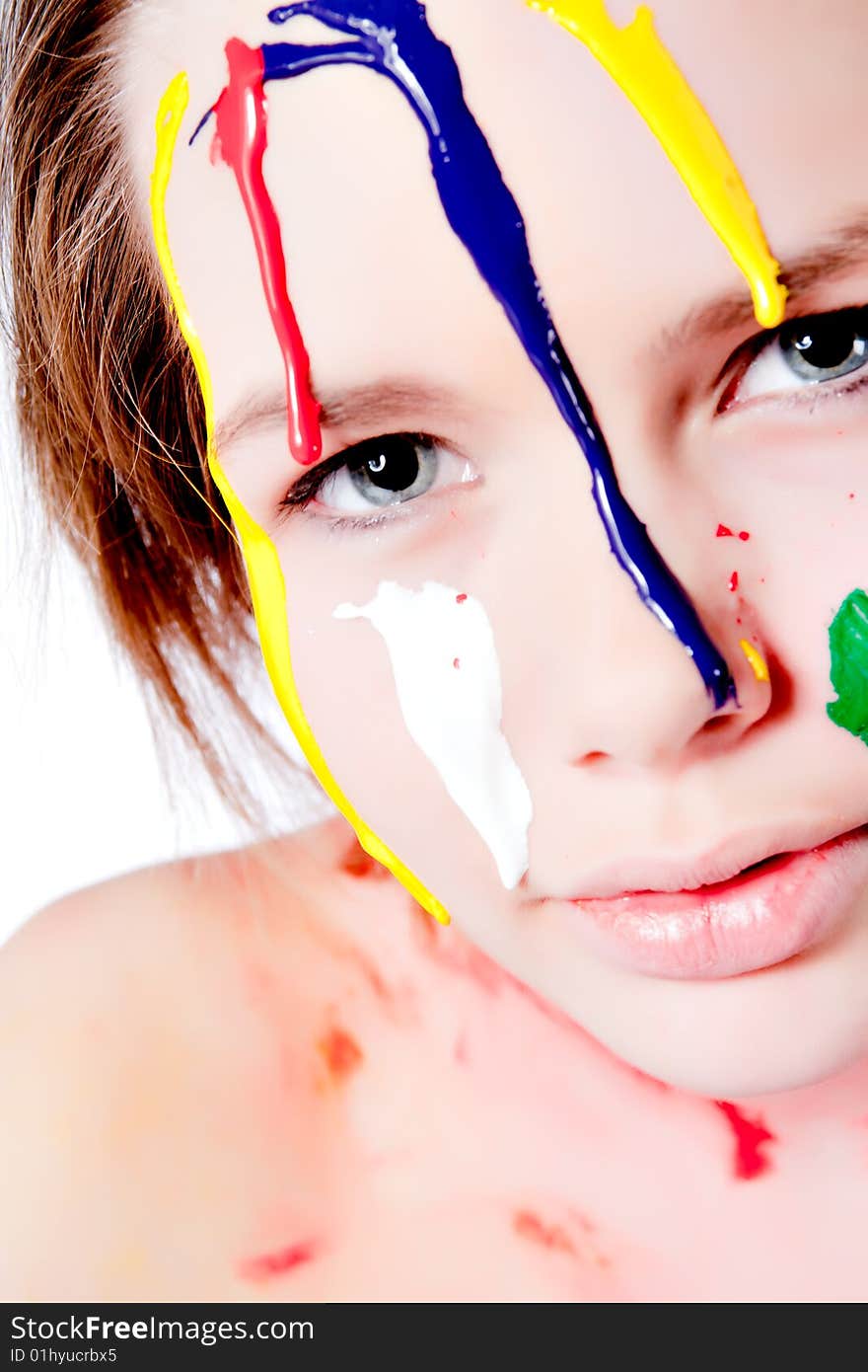 Studio portrait of a teenage girl painting herself. Studio portrait of a teenage girl painting herself