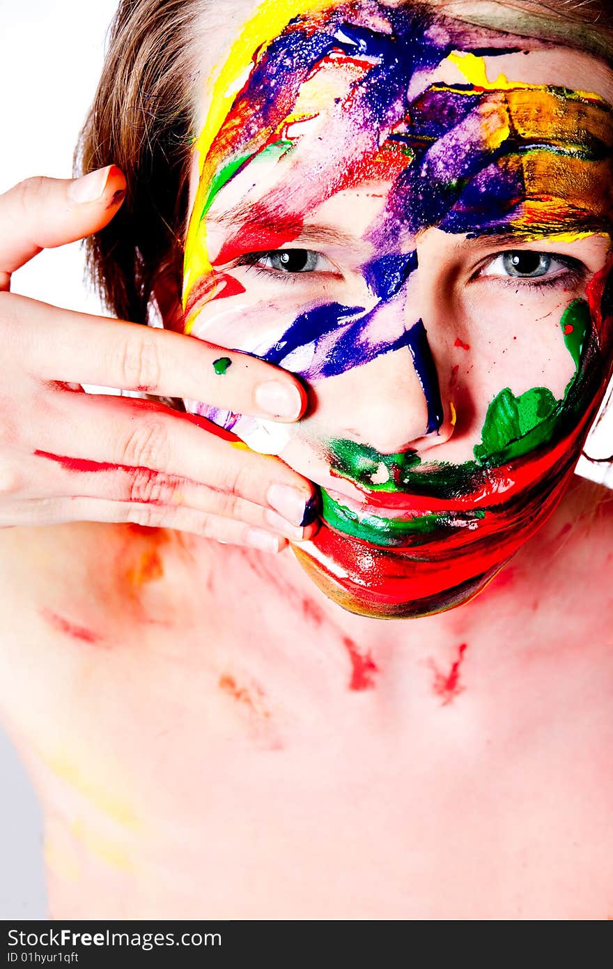 Studio portrait of a teenage girl painting herself. Studio portrait of a teenage girl painting herself