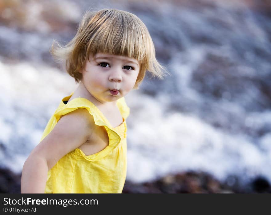 An adorable preschooler puckering her lips in an outdoor portrait. An adorable preschooler puckering her lips in an outdoor portrait.