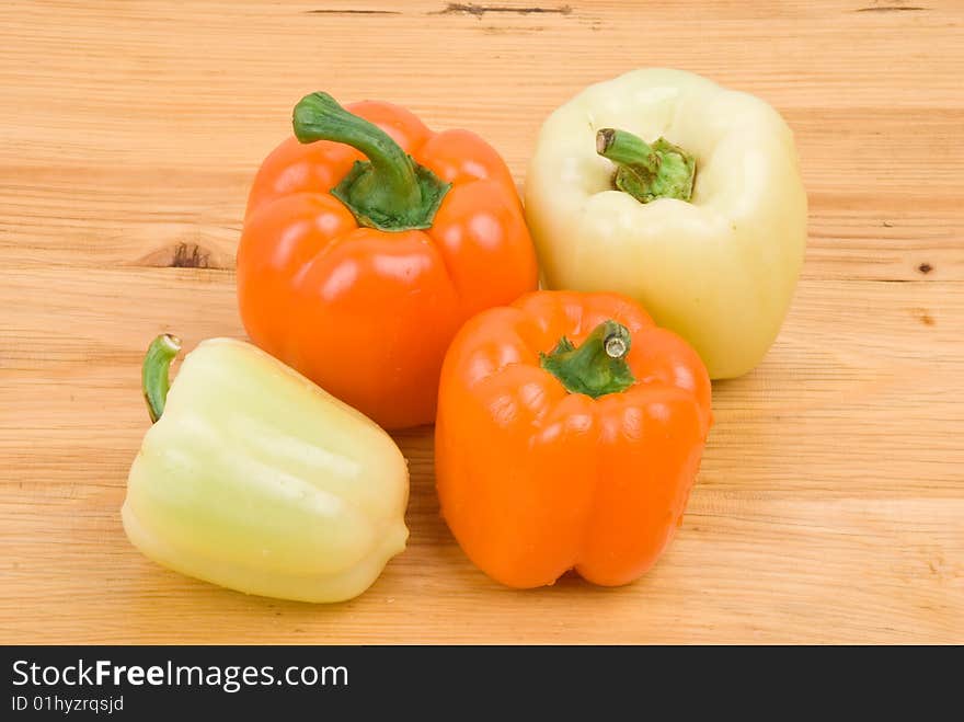 Four different capsicum  orange and light green color on wood table.Check out also <a href=http://www.dreamstime.com/healthy-food-rcollection8217-resi828293>Healthy food</a>. Four different capsicum  orange and light green color on wood table.Check out also <a href=http://www.dreamstime.com/healthy-food-rcollection8217-resi828293>Healthy food</a>