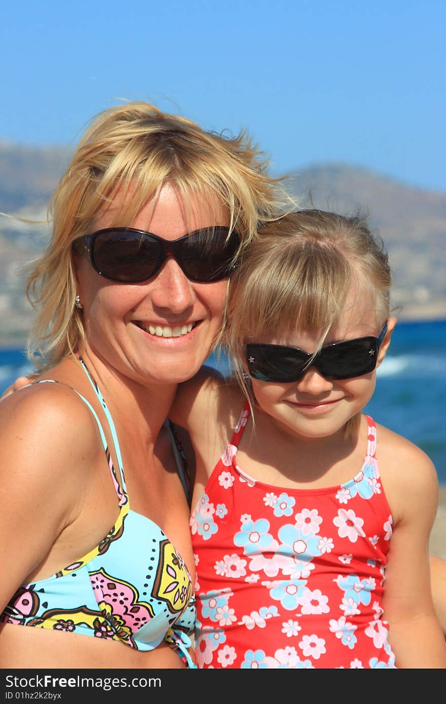 Happy mum with a daughter have a rest on the sea