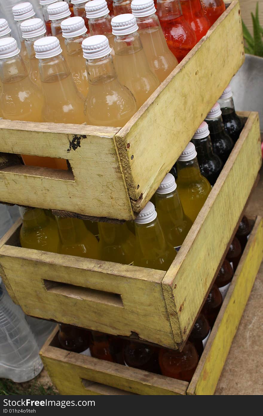 Three timber crates of softdrinks stacked