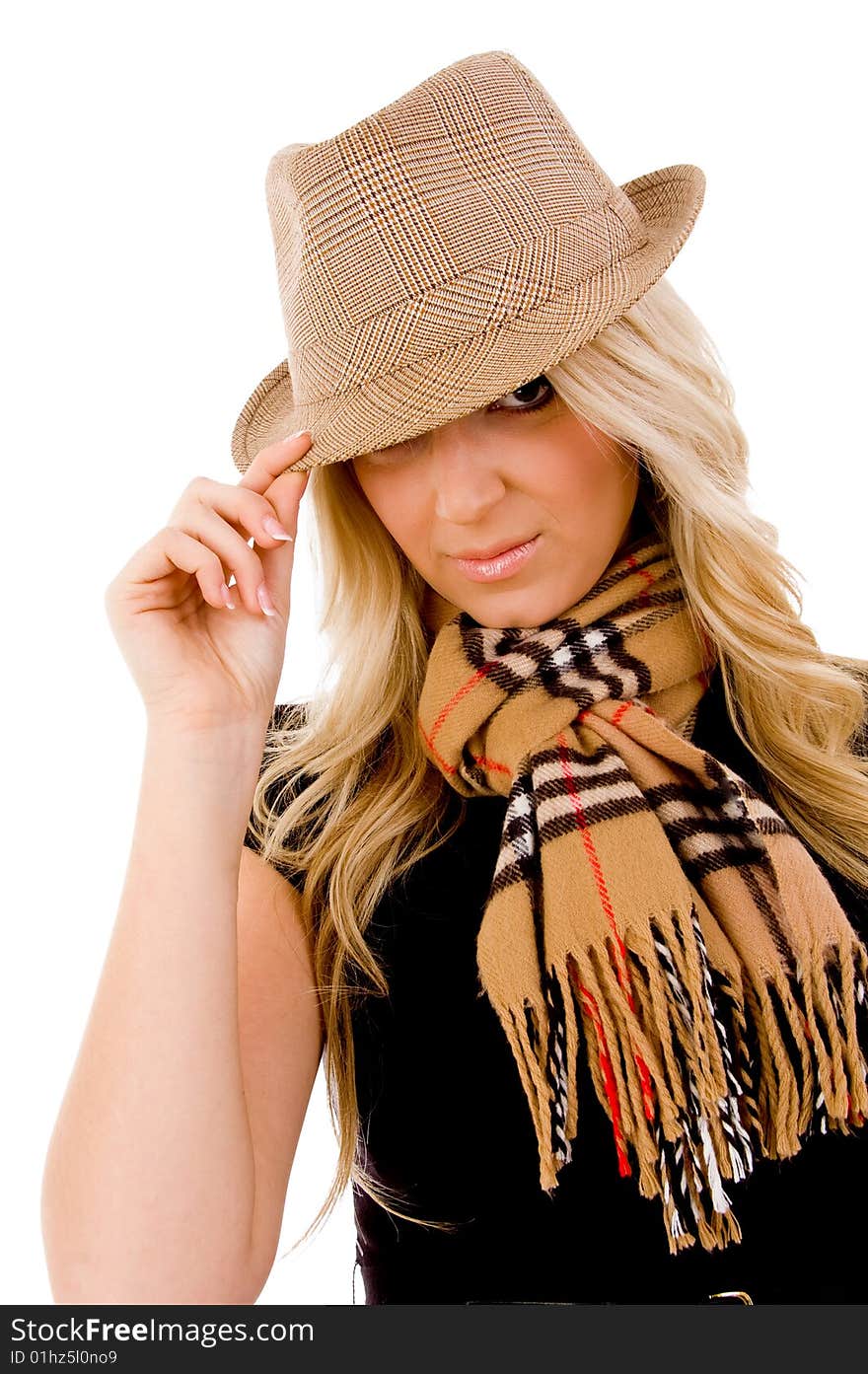 Portrait of smiling young woman holding her hat on an isolated background