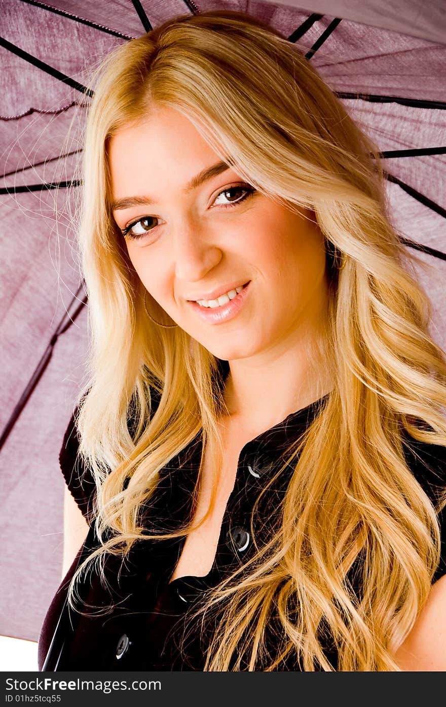 Portrait of smiling female carrying umbrella with white background