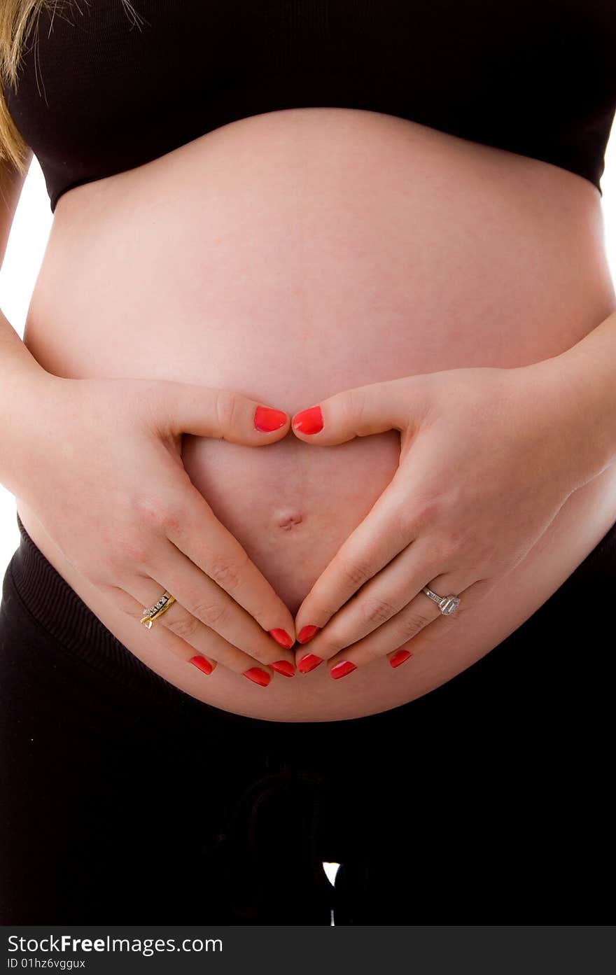 Close up of pregnant woman with her tummy on an isolated background