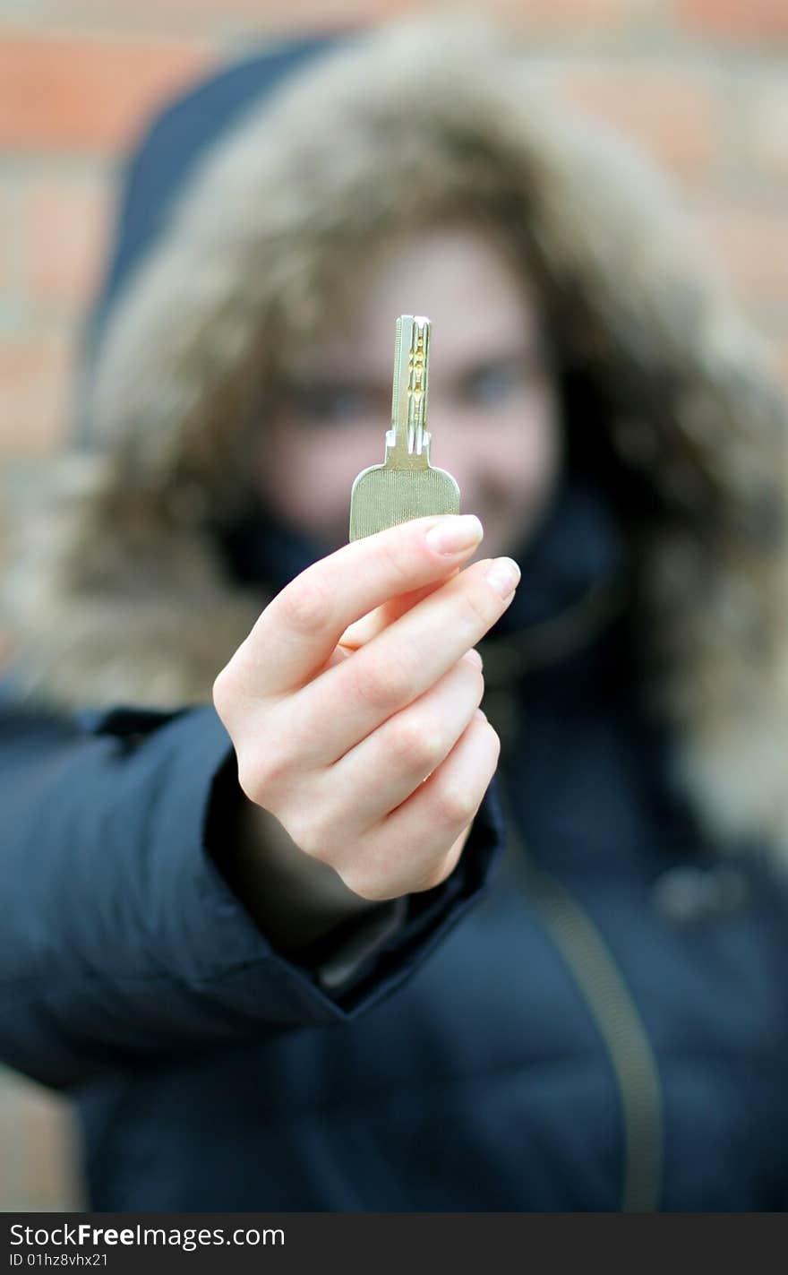 Hand holds a key (key in focus)