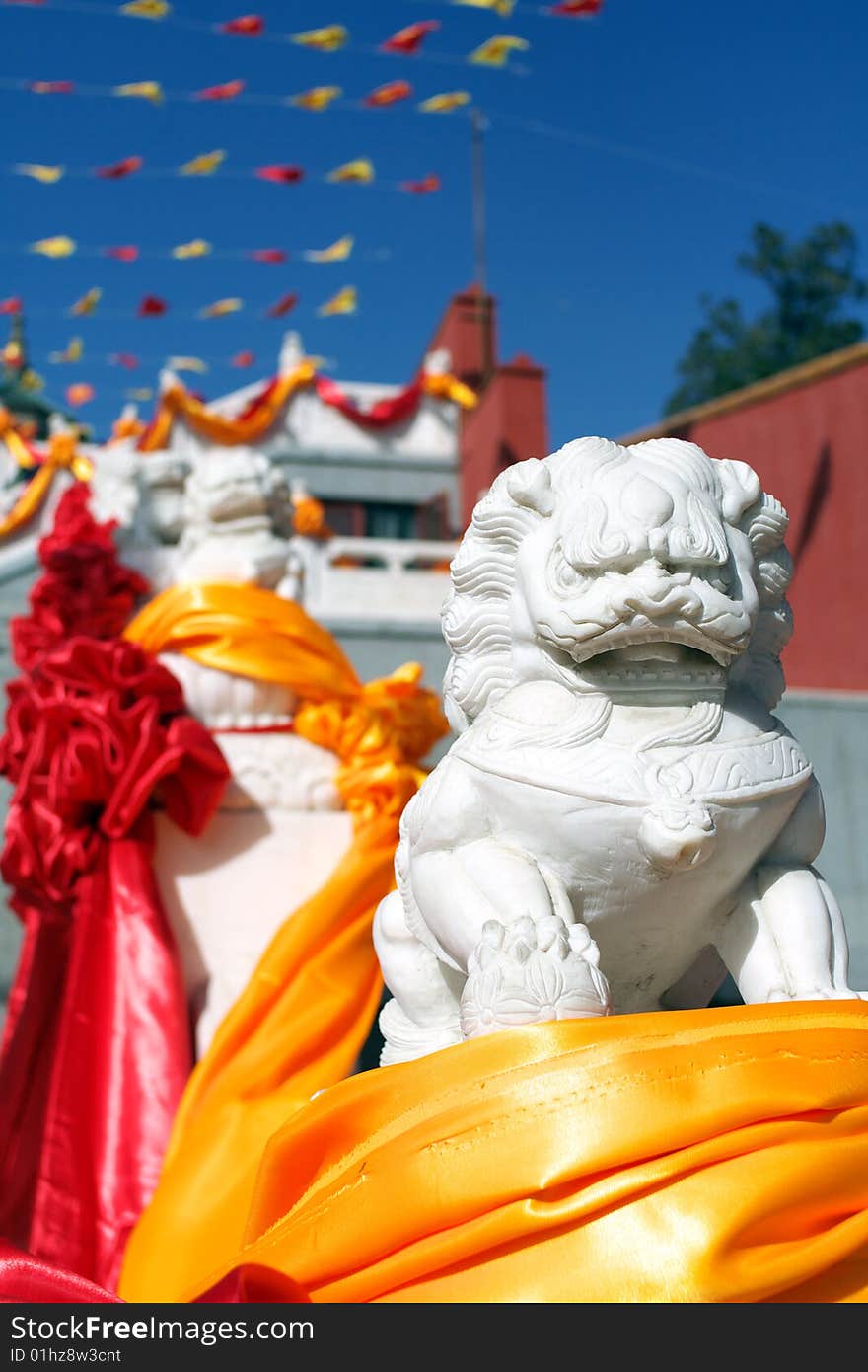 Chinese guardian lions in front of the temple, during buddhist ceremonies