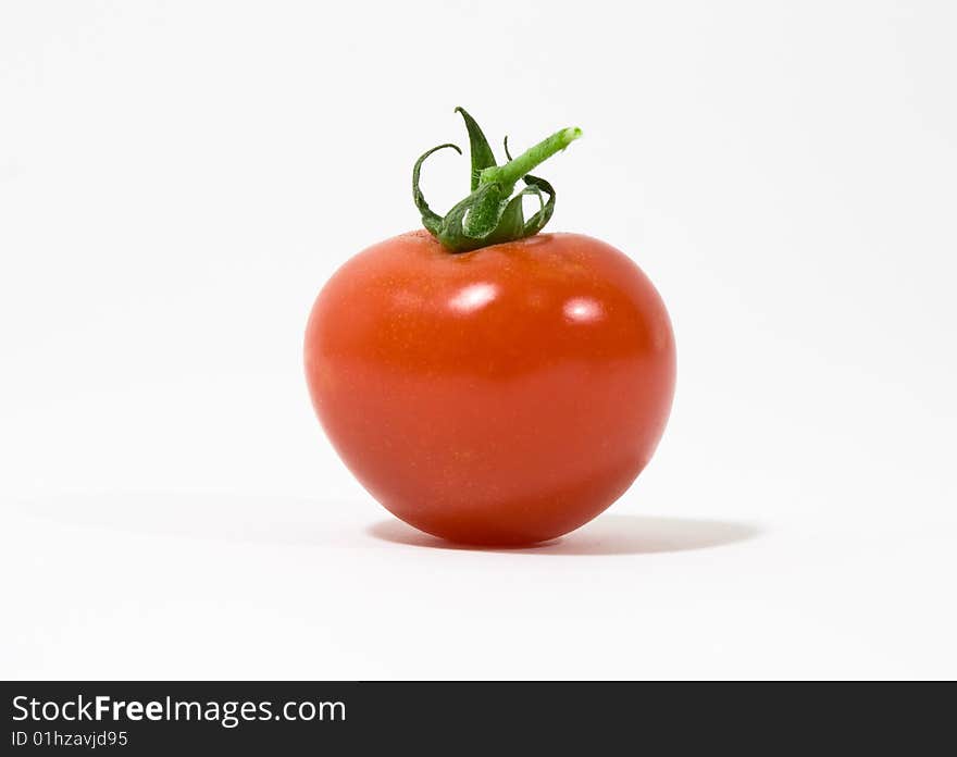 An isolated red tomato on white background. An isolated red tomato on white background