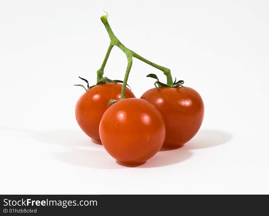 A group of red tomatoes on white background. A group of red tomatoes on white background