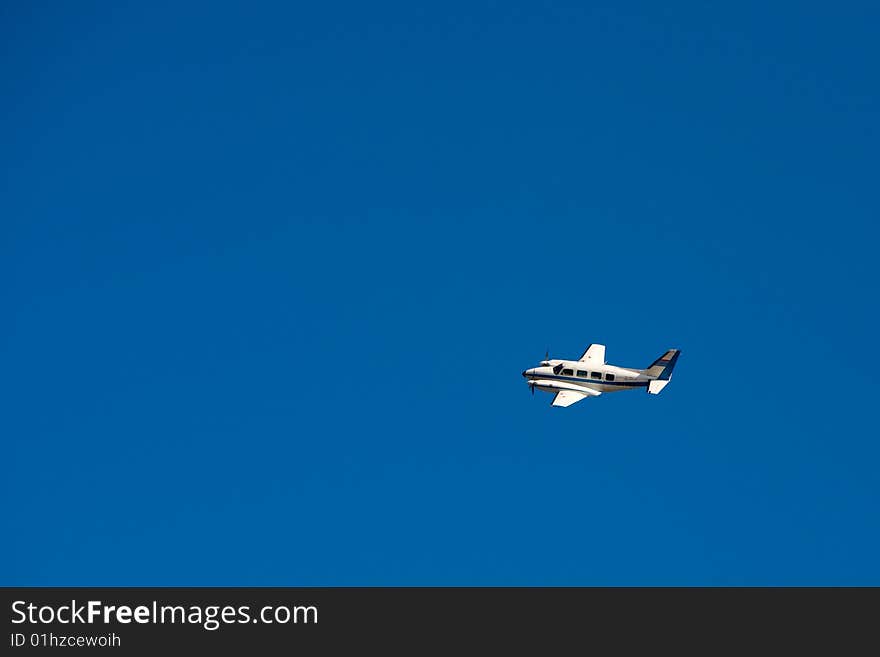 Two engines aircraft flying on blue sky