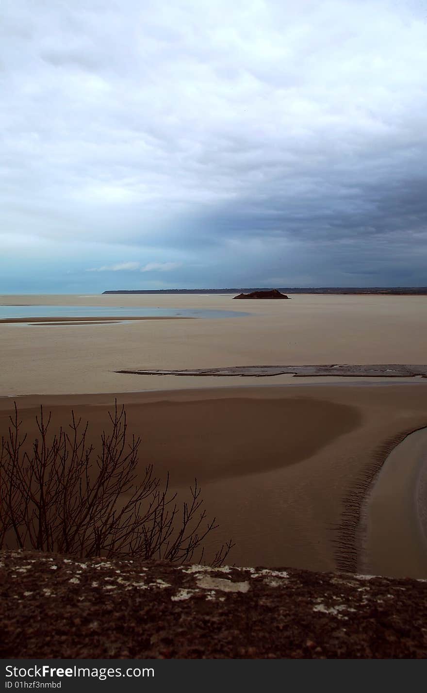 Big sandy landscape in low tide, near Mont St. Michel, France. It was a rainy day. Big sandy landscape in low tide, near Mont St. Michel, France. It was a rainy day.