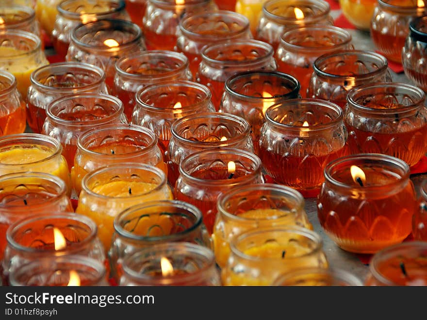 Hundreds of amber-coloured glass votive candles in a courtyard at the Long Xing Temple complex in Pengzhou, China - Lee Snider Photo. Hundreds of amber-coloured glass votive candles in a courtyard at the Long Xing Temple complex in Pengzhou, China - Lee Snider Photo.