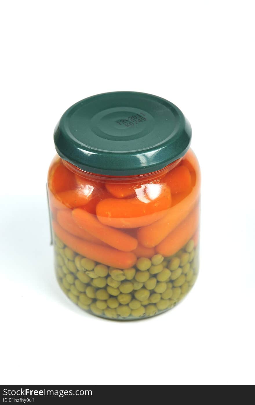 A glass jar with pre-cooked vegetables. A glass jar with pre-cooked vegetables