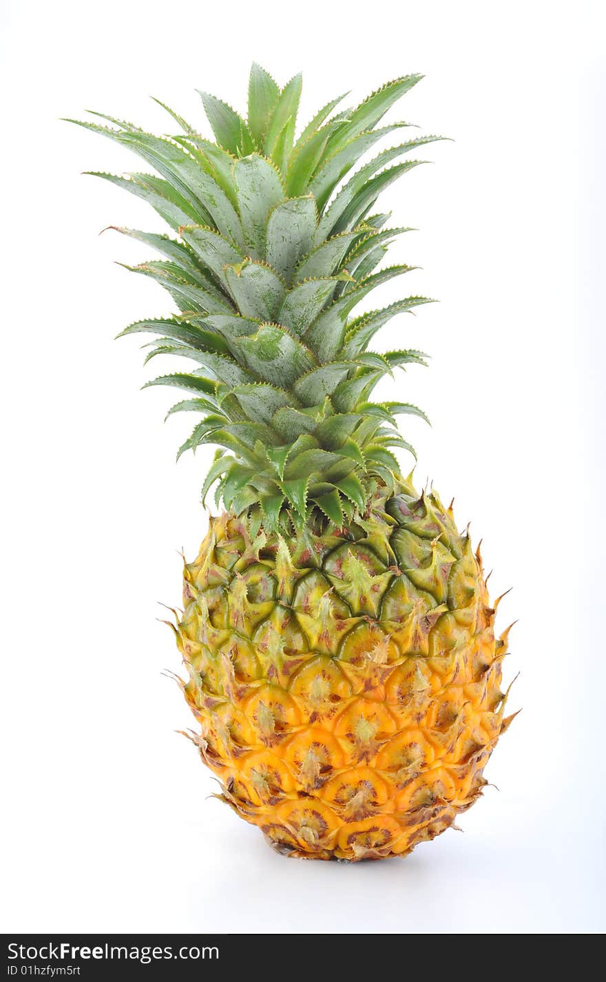 A whole pineapple against a white background.