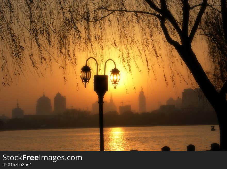 a lamp light beside a lake. a lamp light beside a lake