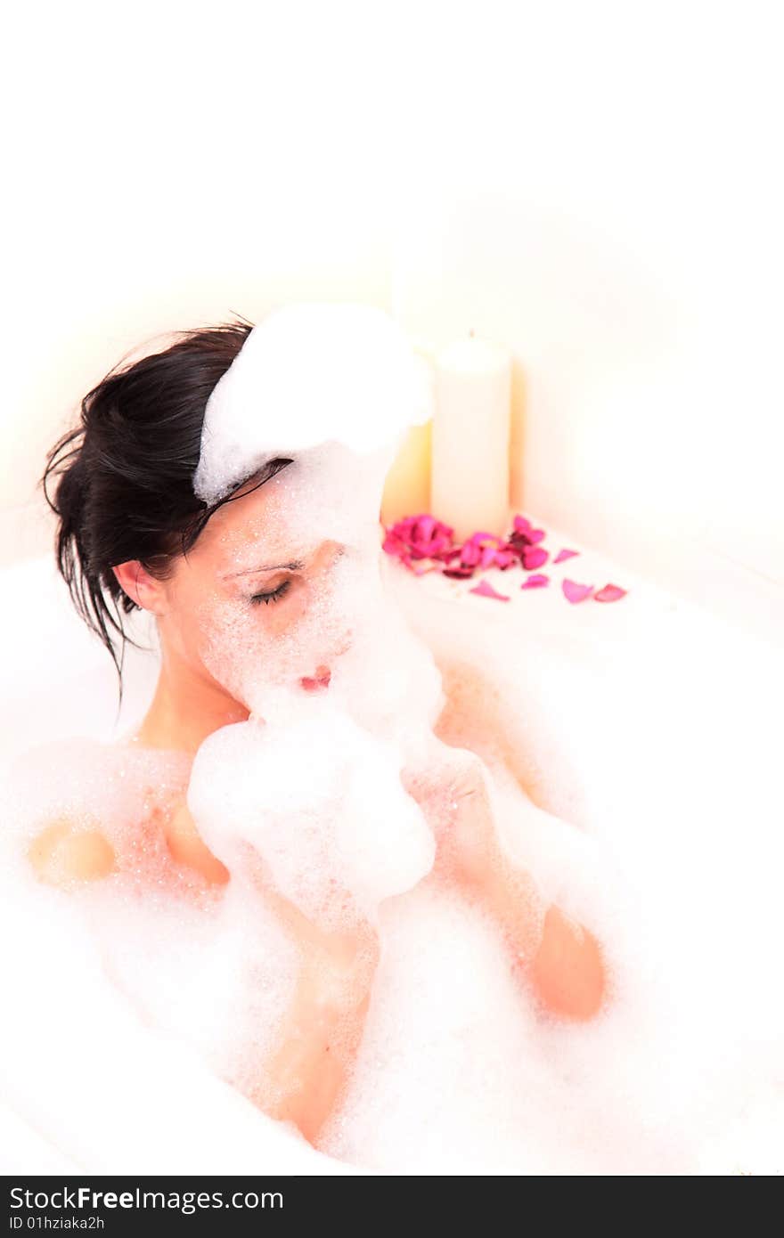 Woman relaxing in bathroam with foam and closed eyes. Woman relaxing in bathroam with foam and closed eyes