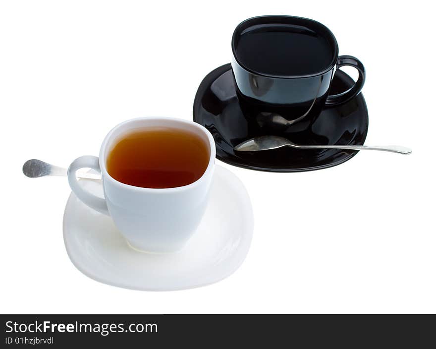 White and black cups with tea